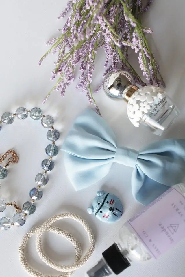 A close-up view of various fashion accessories displayed on a table.  The accessories include items such as bracelets, hats, or sunglasses. Shop fashion accessories at The Hanger.